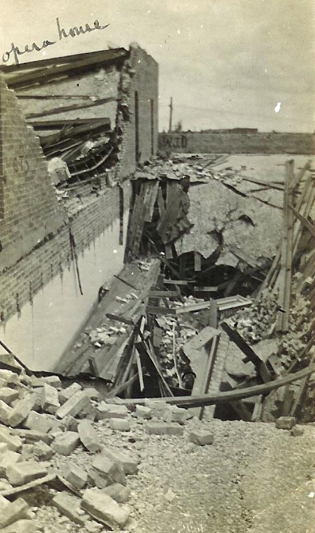 Courtesy of Matagorda County Museum Looking into the wall paper shop in the Langham Bldg. on the south side of the square. The Opera House is on the left, the east wall of the Opera House has fallen through the roof of the wall paper shop.