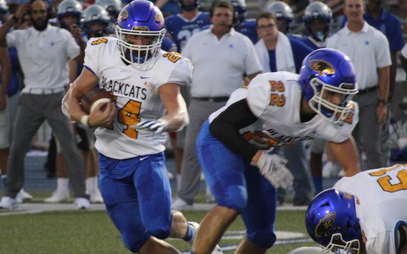 Sentinel file photo Blackcat junior running back Ayden Smith (24) works his way through defenders.