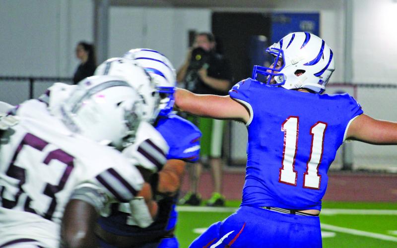 Tidehaven quaterback Logan Crow (11) prepares to throw in last Friday’s game with Industrial. Sentinel photo/Mike Reddell