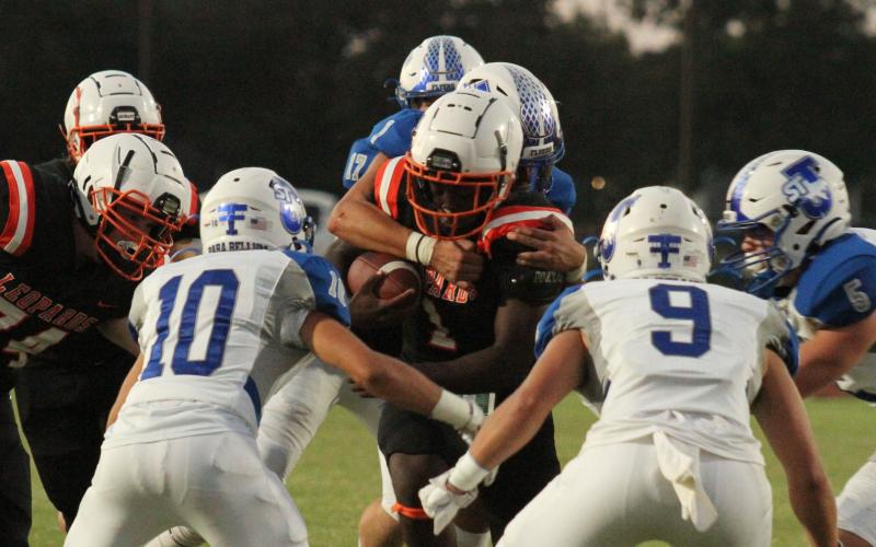 Photo/Anna Hernandez Van Vleck running back Alfredo Vazquez (1) runs the ball up the middle of St. Joseph defenders and runs into trouble.
