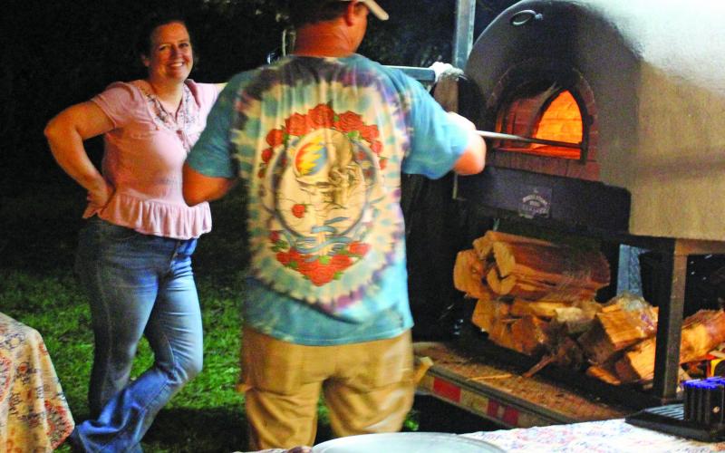Right, Full Moon Woodfired Pizza truck owner Jason Coleman works on the next pizza for customers during the Matagorda County Birding and Nature Center's annual Full Moon Food Truck Festival Saturday, Oct. 23.  Sentinel photos/Jessica Shepard
