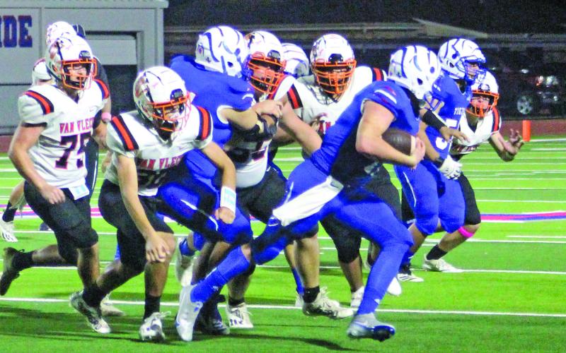 Sentinel photo/Jessica Shepard Tidehaven quarterback Logan Crow looks to pick up blocks as he runs wide against the Van Vleck Leopards last Friday night.