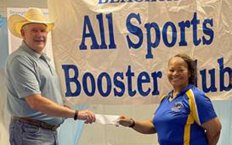Contributed photo Chris Green with Orsted hands a check to Janice Hopes, Blackcat All-Sports Booster Club, to support the boys and girls sports programs of Bay City ISD. Orsted operates 1.7 GW of wind projects across the U.S. and is developing an approximately 300 MW wind project in Matagorda County, which will help meet the energy needs of Texas during peak demand periods by providing reliable and flexible wind-powered electricity.