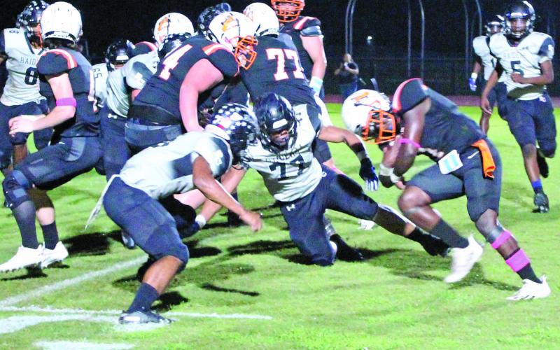 Sentinel photo/Jessica Shepard Van Vleck running back (1) puts his head down as he preparares to get past Rice defenders on the goal line.