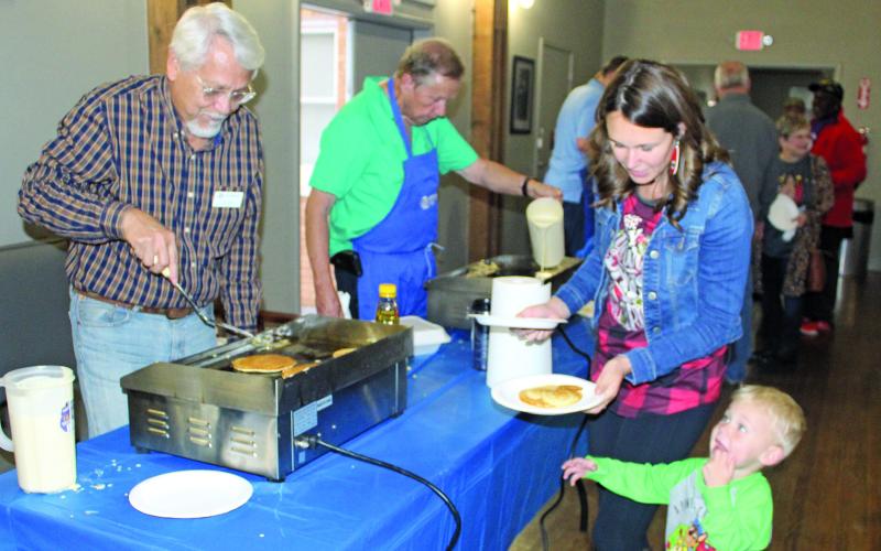 Sentinel photo/Jessica Shepard The annual Boys and Girls Club annual Pancake supper drew crowds of adults and children alike, Thursday, Dec. 17. Pancake Supper veteran volunteer Steven Reis, left, plated a special-themed Mickey Mouse pancake for one youngster eagerly watching and waiting to dig in.