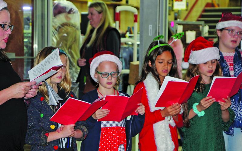 Sentinel photo/Mike Reddell Holy Cross Catholic School's student choir sang Christmas carols in front of Wild Bill's Western Wear as part of the annual "Christmas Around the Square" event, Thursday, Nov. 18.