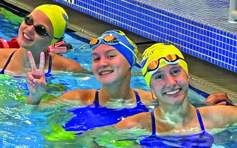 Photo/Shelby Luder Bay City swimmers, from left, Lucy Frick, Victoria Sliva and Megan Moya in a happy moment at Rosenberg meet. The three won first in the Girls 200 Yard Freestyle Relay at Rosenberg.