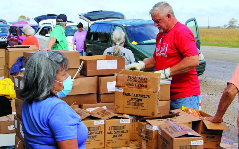 Sentinel photo/Mike Reddell Harvest House distributed 32,335 pounds of food - enough for 400 Matagorda County residents - from the O.H. Herman building Thursday, Nov. 11. Organizer Willie Rollins estimated a line of cars for the distribution was about a mile long. He said 25 volunteers helped with the distribution.