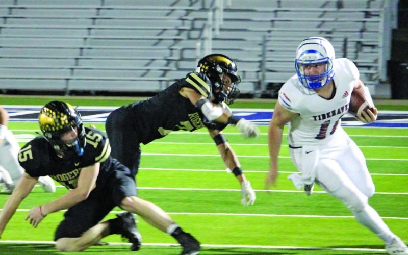 Sentinel photo/Jessica Shepard Tidehaven quarterback Logan Crow (11) looks upfield on a run against Rogers in the bi-district championship game Nov. 12. Crow was the game’s leading rusher with 304 yards and two touchdowns.