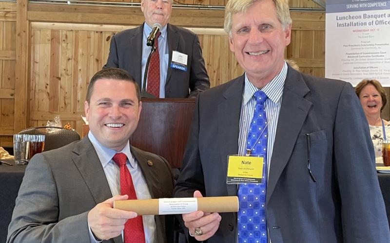 Contributed photo Matagorda County Judge Nate McDonald, right, accepts his Commissioners Court Advanced Curriculum Certificate of Achievement from Victoria County Judge Ben Zeller, 2020-21 president of the County Judges and Commissioners Association of Texas.