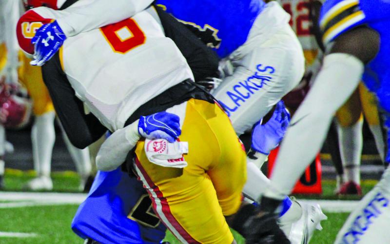 Sentinel photo/Mike Reddell Blackcats put the squeeze on a Stafford running back.