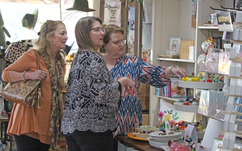 Sentinel photo/Jessica Shepard A trio of shoppers took advantage of special sales and refreshments at Homestead. Everything from Glitter to Rust during the Bay City Main Street Programs' first-ever "Witches Who Wine" event, Thursday, Oct. 28.