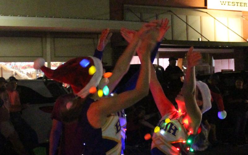 Bay City Junior High cheerleaders catch a teammate during her dismount at the annual Lighted Christmas Parade, Friday, Dec. 3. The group was just one of over 45 entries in the parade that night. Sentinel photo/ Jessica Shepard