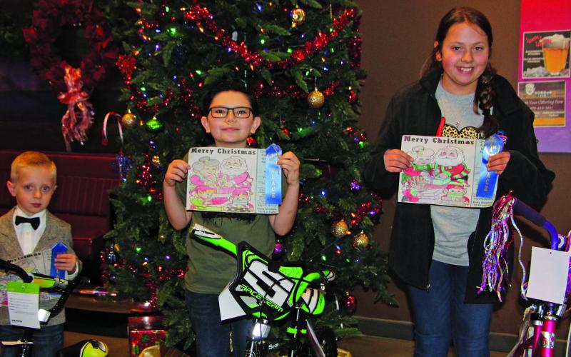 Sentinel photo/Mike Reddell The Bay City Sentinel’s 2021 Christmas Coloring Contest winners were awarded their bicycles and yuletide stockings stuffed with holiday treats Sunday, Dec. 19. The winners are, from left: Logan Theiss, age group 2-4; Zack Hickl, age group 5-8; and Fae Huddleston, age group 9-12.