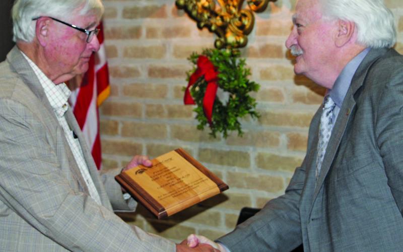 Sentinel photo/Mike Reddell  Bill Cornman, left, receives the 2021 George Holst Award from last year’s recipient, Glen Smith, at Matagorda County Economic Development Corporation’s annual banquet Dec. 8.