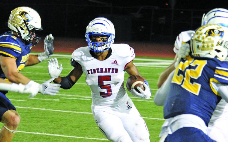 Sentinel photo/Mike Reddell Tidehaven sophomore running back Joseph Dodds (5), who had 141 all-purpose yards against Poth, looks for an opening created by his Tiger blockers.