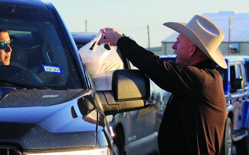 Sentinel photo/Jessica Shepard Precinct 1 Constable Doug Schoppe, right, hands out to-go plates as part of the Crisis Center's annual chicken fried steak fundraiser Jan. 21. Proceeds from the event help the center maintain its services to Matagorda and Wharton county residents.