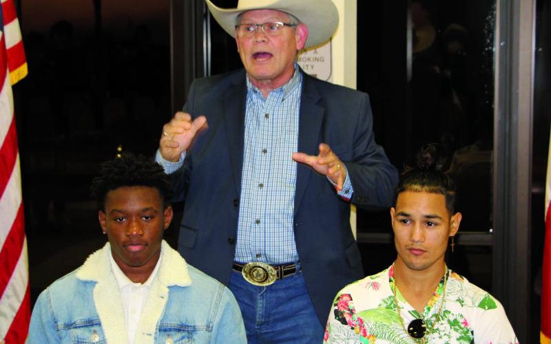 Sentinel photo/Mike Reddell Houston boxing promoter Termite Watkins (center) explains future of local boxers Kanye Gee from Bay City (left) and Tim Longoria from Palacios. The two signed professional contracts as boxers at an event Thursday, Jan. 6.