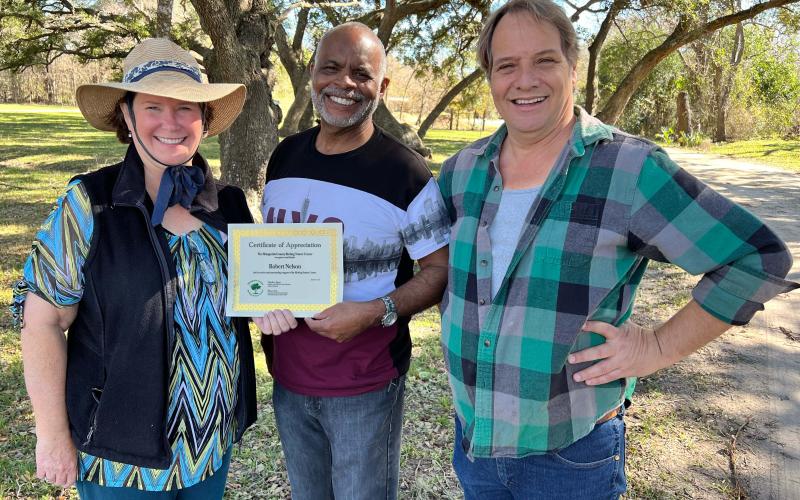 Robert Nelson, center, recently received a certificate of appreciation from Matagorda County Birding Nature Center board members Becca Sitz, left, and Stephen Logan, far right. Nelson was the winner of the Center’s "Save The Slithering Slough" fundraiser event held during the Dec. 20 Audubon Christmas Bird Count. Contributed photo