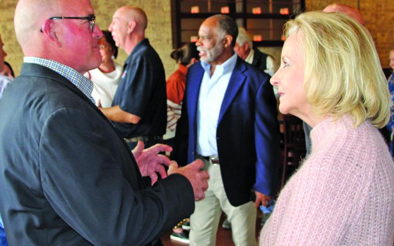 Sentinel photo/Mike Reddell John Runnels III explains a point with State Rep. Geanie Morrison at a reception for her Feb. 15.