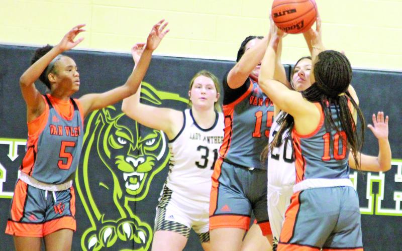 Photo/Anna Hernandez Van Vleck’s Jaila Williams (15) and Carlysia Gibson (10) box in a Danbury player I. Schraven (20) during last week’s game that the Leps (16-11, 5-6) won 37-34. Van Vleck is fourth in district.