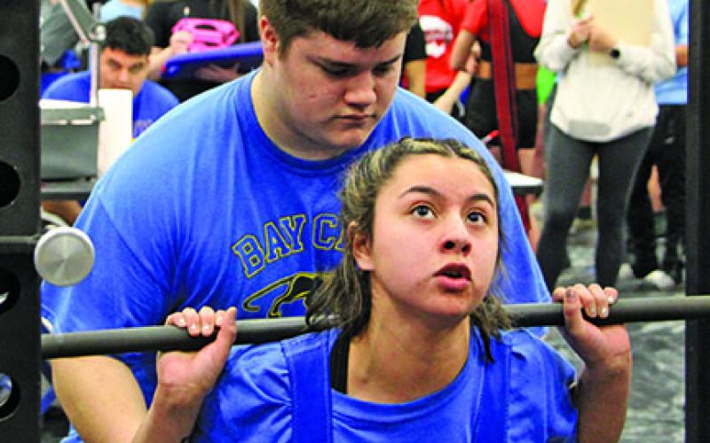 Sentinel photo/Mike Reddell Bay City High School Powerlifter Alexis Alvarez takes on the standing press at the Regional Powerlifting Tournament at BCHS last week..