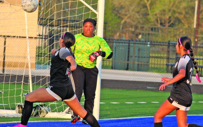 Sentinel photos/Mike Reddell Ladycats converge at goal net against Houston North Shore in a bi-district championship game that Bay City won 16-0 Saturday, March 26.