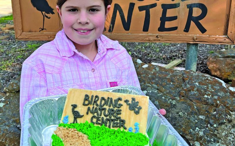 Contributed photo Matagorda County Fair &amp; Livestock Association Home Economics Junior Division Decorated Desserts Reserve Grand champion Clara Dodd presented her ribbon-winning cake to the Matagorda County Birding Nature Center Thursday, March 16. Dodd was presented a check for her cake with the encouragement for her to continue exploring nature and participating in El Maton 4-H Club activities.
