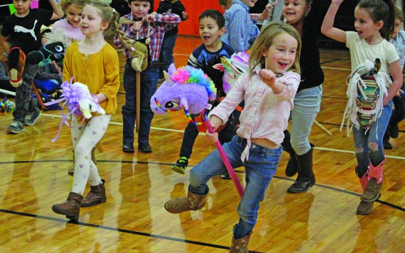 Sentinel photo/Jessica Shepard Van Vleck Elementary kindergarten students showed off their stick-horse bronco riding skills during the campus' "Kindergarten Rodeo" Friday, March 11. Other rodeo events included barrel racing and riding steers.