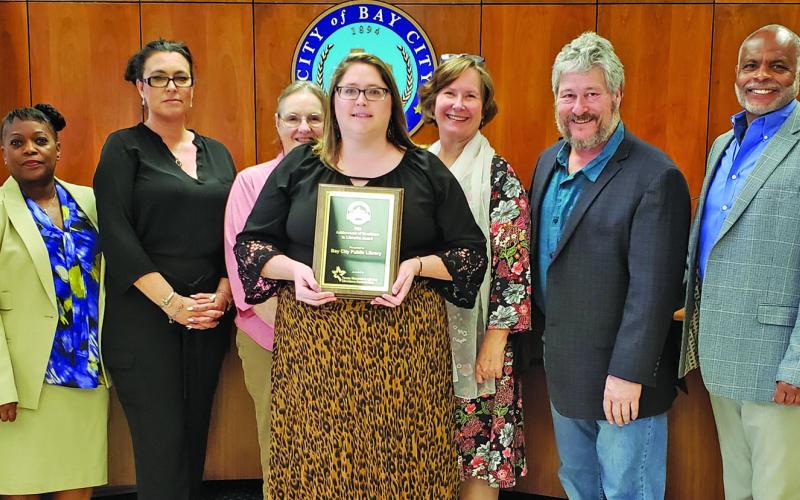 Sentinel photo/Jessica Shepard City Council joins Bay City Public Library Director Samantha Denbow, center, in celebrating the library's Texas Municipal Library Directors Association 2021