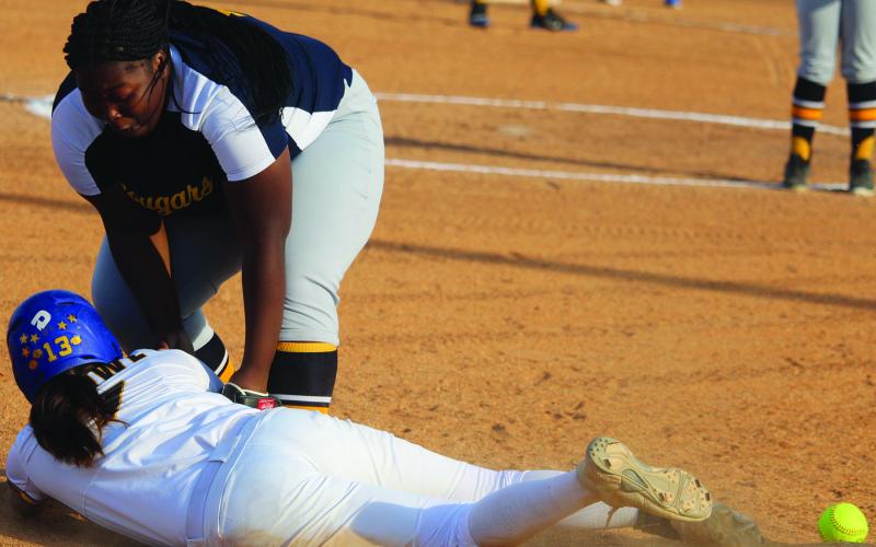 Sentinel photos /Mike Reddell  Bay City dispatched La Marque 16-0 in two innings Friday, April 1. A La Marque third baseman attempts to put out a Ladycat base runner without the ball.