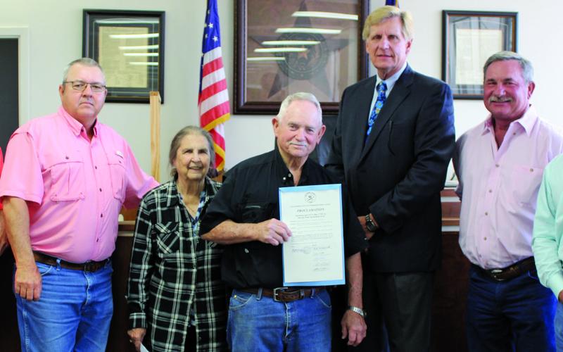 Sentinel photo/Jessica Shepard Soil and Water Conservation board member Billy Mann and his wife Linda, center, were joined by commissioners when receiving a proclamation naming the week of April 24 to May 1 as “Soil &amp; Water Stewardship Week” Monday, April 18.