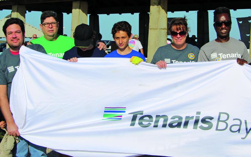 Above, this group of Tenaris employees joins 75 other volunteers flocking to Matagorda Beach for the Texas General Land Office's Adopt-A-Beach spring cleanup, Saturday, April 9. Sentinel photo/Mike Reddell