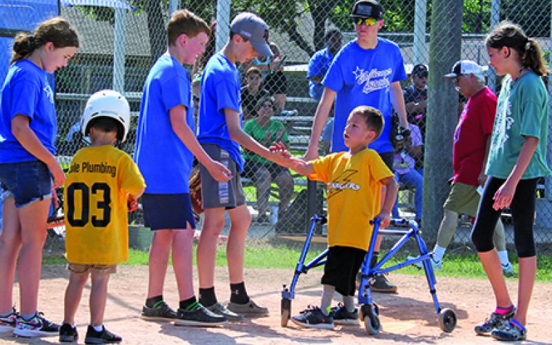 Sentinel photo/Jessica Shepard Dakota coming across home to get high 5’s from buddies.