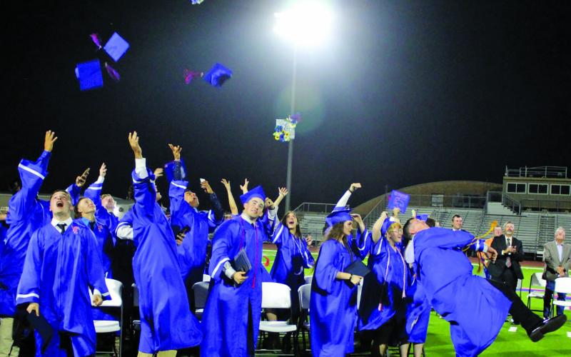 Sentinel photo/Jessica Shepard Tidehaven High School seniors launch their caps at the conclusion of commencement ceremonies at Delvin Taska Stadium, Friday, May 20.