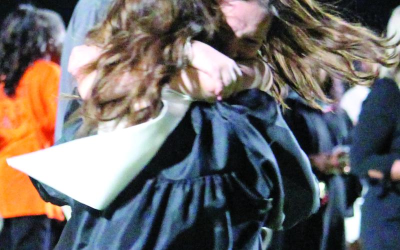 Sentinel photo/Jessica Shepard After their graduation ceremony, the Van Vleck High School class of 2022 shared their excitement with friends and family members in many ways - like this spirited hug Thursday, May 26.