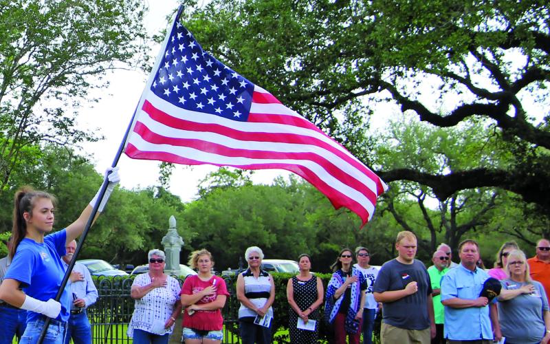 Sentinel photo/Mike Reddell A flag presentation by the Junior Girls Auxiliary for Memorial Day services at Hawley Cemetery including U.S. and Armed Services flags.