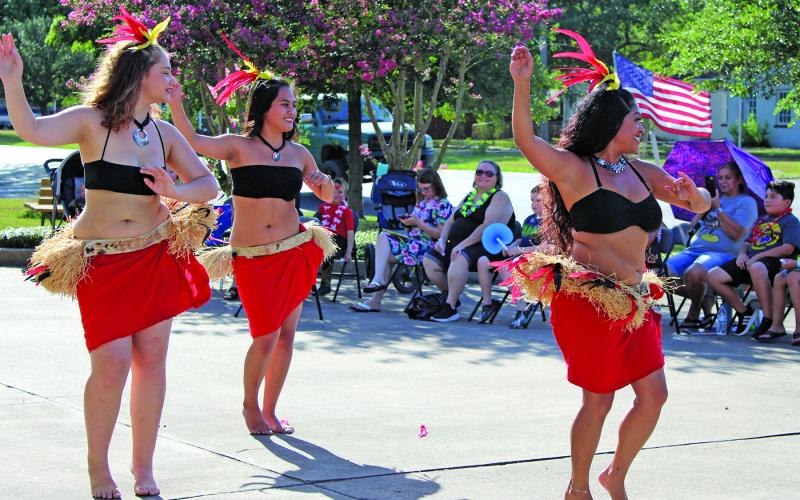 Sentinel photo/Jessica Shepard This trio of Hiti Mahana Polynesia dancers showed off their traditional dancing skills as part of the Bay City Public Library's "Community Luau" event, Thursday, June 23. Hiti Mahana Polynesia also taught audience volunteers several dance moves and provided a variety of songs to entertain the crowd.