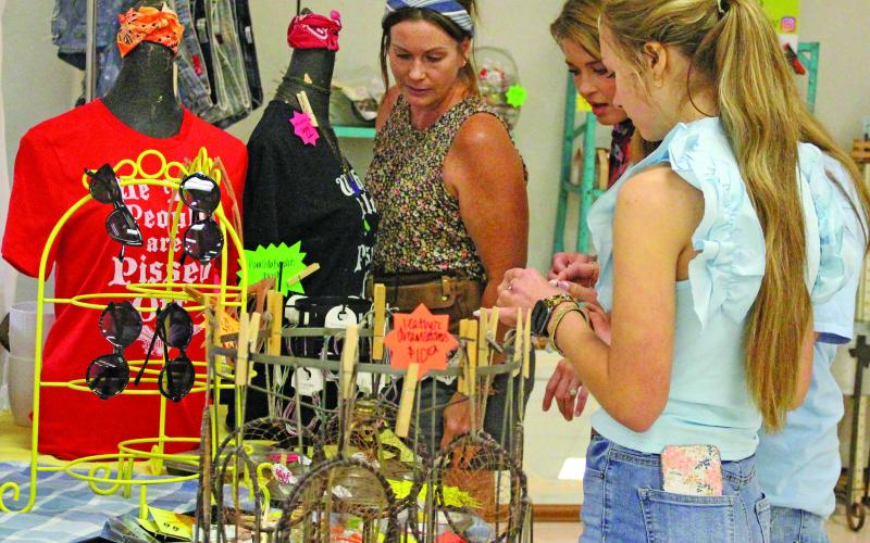 Several women flocked to Pura Vida's Market Days booth to check out her jewelry selection Saturday, June 18. Other booths at the Bay City Chamber of Commerce and Agriculture Indoor Market Day displayed candles, soaps, wine, and homemade desserts.  Sentinel photo/ Jessica Shepard