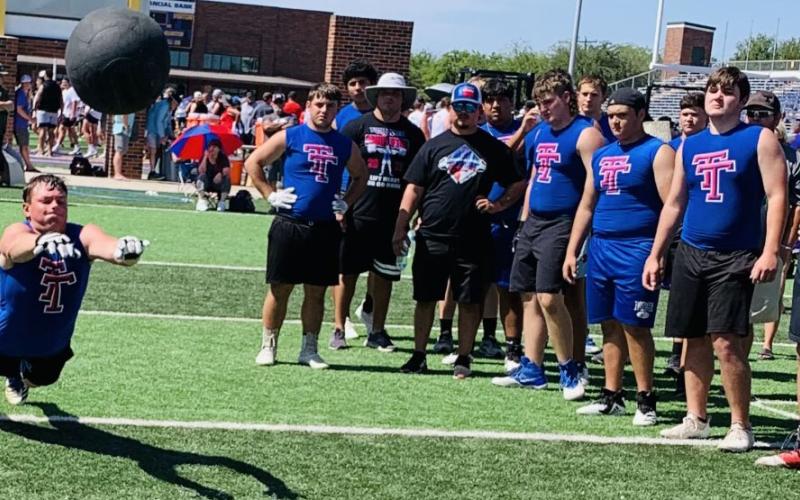 Photo  courtesy of Deeana Sneath Tidehaven’s Clyde Griffith puts his effort into a kneeling medicine ball throw at the Lineman Challenge.