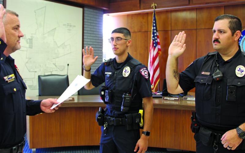 Sentinel Photo/Mike Reddell Bay City Police Chief Robert Lister swears in two new officers, John Alvarez, center, and Charles Coombs during a swearing-in ceremony July 6 at City Hall.