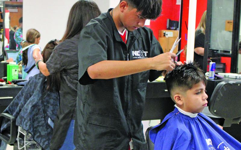 Sentinel photo/Jessica Shepard Local hairstylists and barbers provided free haircuts to Bay City ISD students during the district's "Back to School Bash" Thursday, Aug. 11. The stylists worked throughout the entire event for children of all ages.