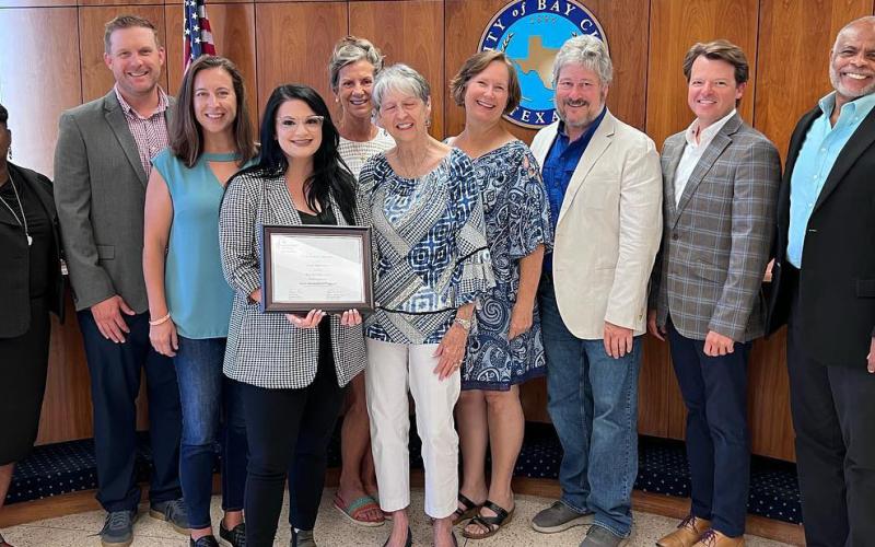 Sentinel photo/Jessica Shepard Bay City Main Street Program Manager Tina Israel, center, is joined by board members Fran Baker and Jennifer Bishop, while showing off the Main Street America Program and Texas Main Street Accreditation certification as a Main Street America program for meeting rigorous performance standards during the regular city council meeting on July 26. Israel told council the award was based on 2021 work and events downtown.