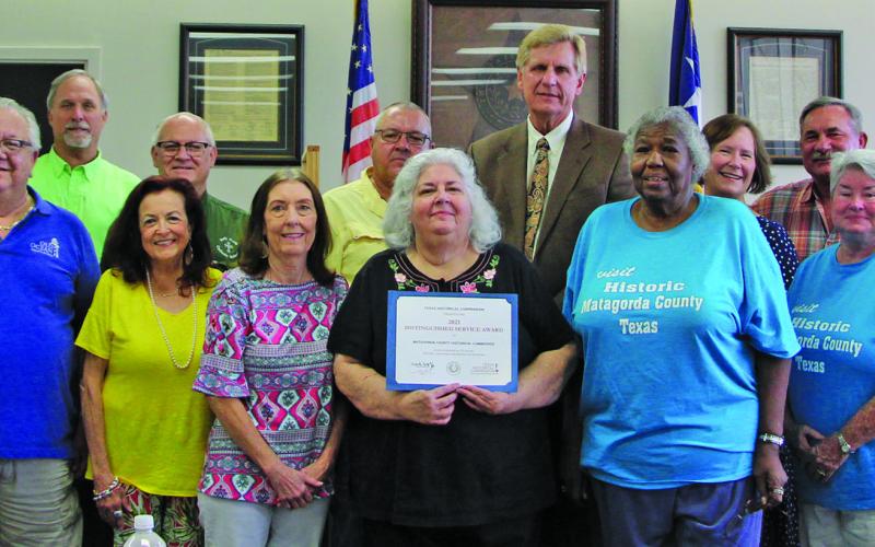 Photo by Stephanie Wurtz Matagorda County HIstorical Commission (MCHC) members are shown with the Commissioners Court, which presented the commission with a Distinguished Service Award from the Texas Historical Commission (at right) at the court’s regular meeting Monday, Aug. 22.