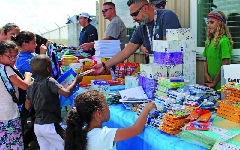 Sentinel Photo/MaLinda Reddell RWE Renewables Peyton Creek Wind Farm held a school supply drive for Matagorda ISD Aug. 15. The wind farm provided backpacks with school supplies for elementary and middle school students and had a bounce house set up.
