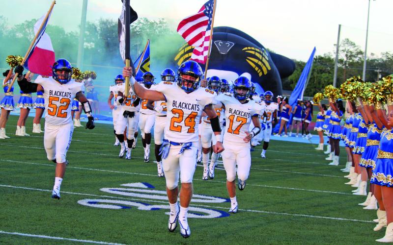 Sentinel Photo/Mike Reddell The Blackcats traditional entrance to the field marked a new season for Bay City, along with the Aristocats and Cheerleaders.