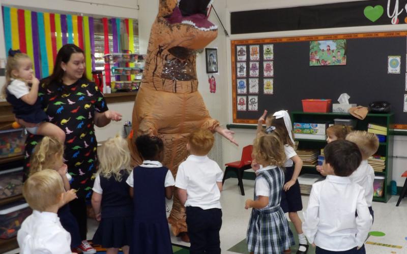 Courtesy photo Holy Cross Catholic School Pre-K 3 students had a dinosaur visit Ms. Lacy’s class. Mrs. Russell - one of the school’s parents - wore her awesome dinosaur costume to teach the students about the letter "D." Most of the students were ecstatic and Mrs. Escobar actually pulled the dinosaur’s tail.
