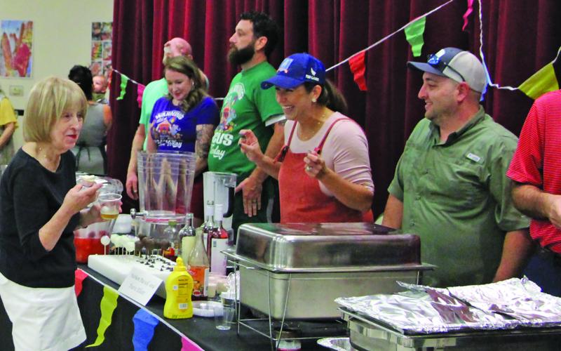 Retired Bay City teacher Connie Corman engages cooking teams at the Gourmet Guys at the Bay City Civic Center Saturday night, Sept. 24. The annual event is the only fundraiser for the Matagorda County Museum. This year’s event drew about 175 people. Sentinel Photo/Mike Reddell
