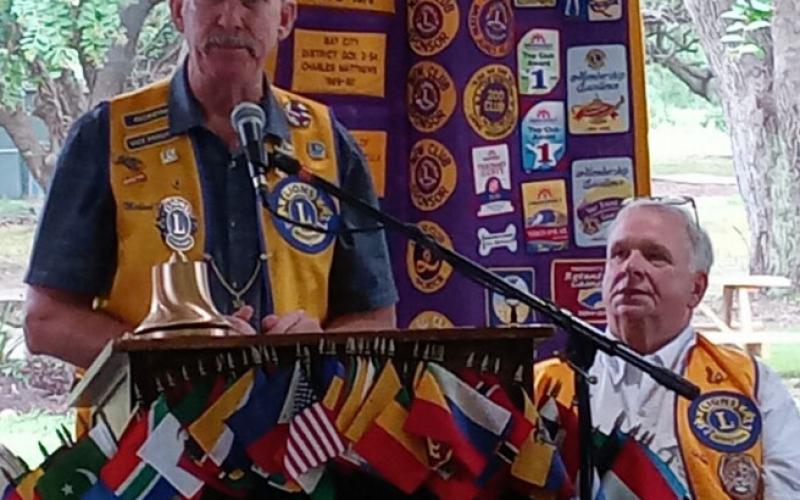 Courtesy photo Bay City Lions Club's New President Mike Finster addresses club members at a recent meeting, as outgoing president Steven Johnson listens.