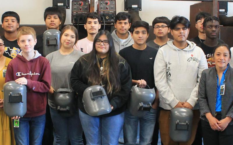 Contributed photo Bay City High School welding students, teachers and administrators join representatives and welders from Phillips 66-Sweeny Refinery, in marking the refinery’s donation of 20 welding hoods to the BCHS welding program.
